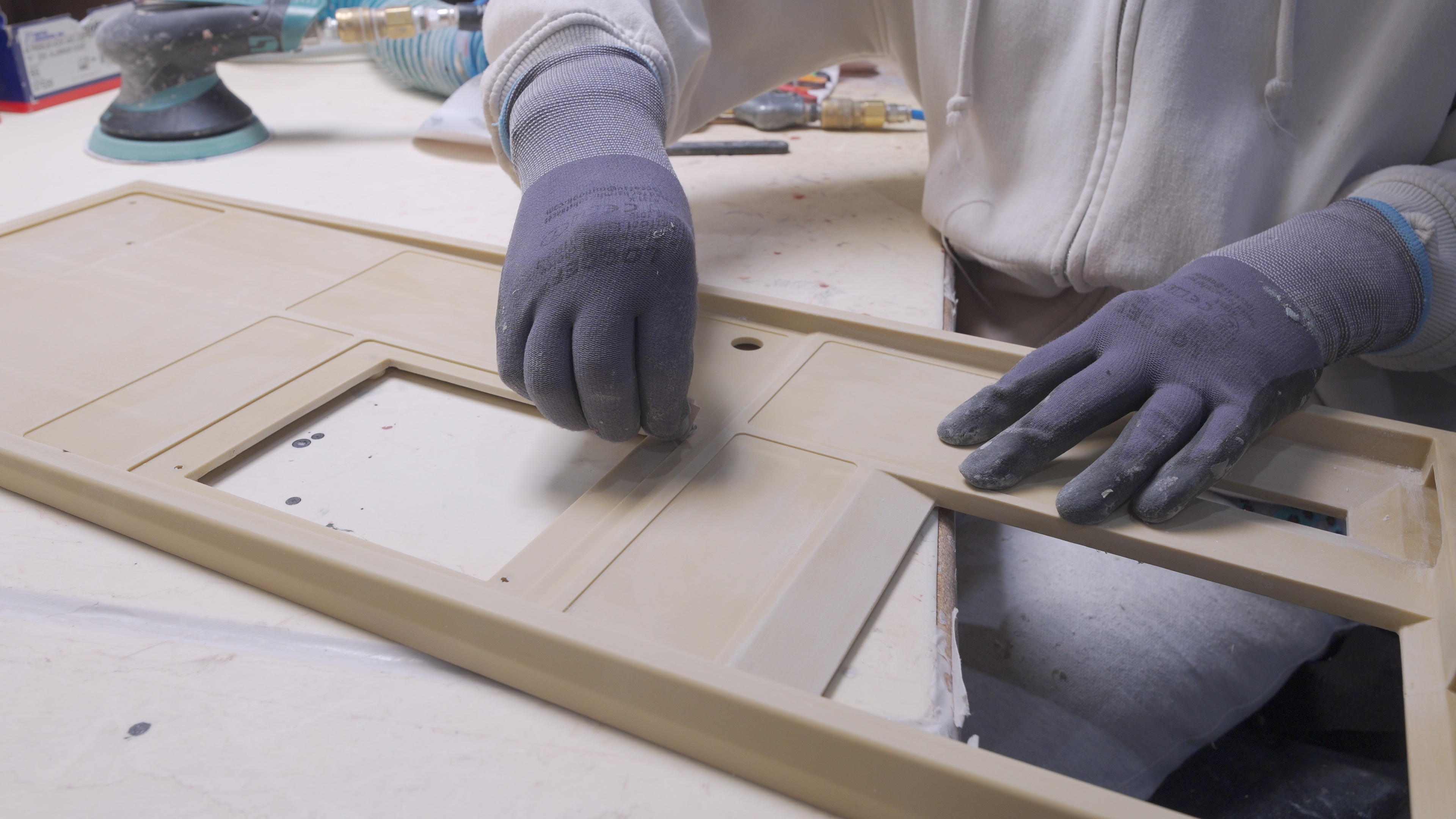 a RIM molded part being sanded by hand