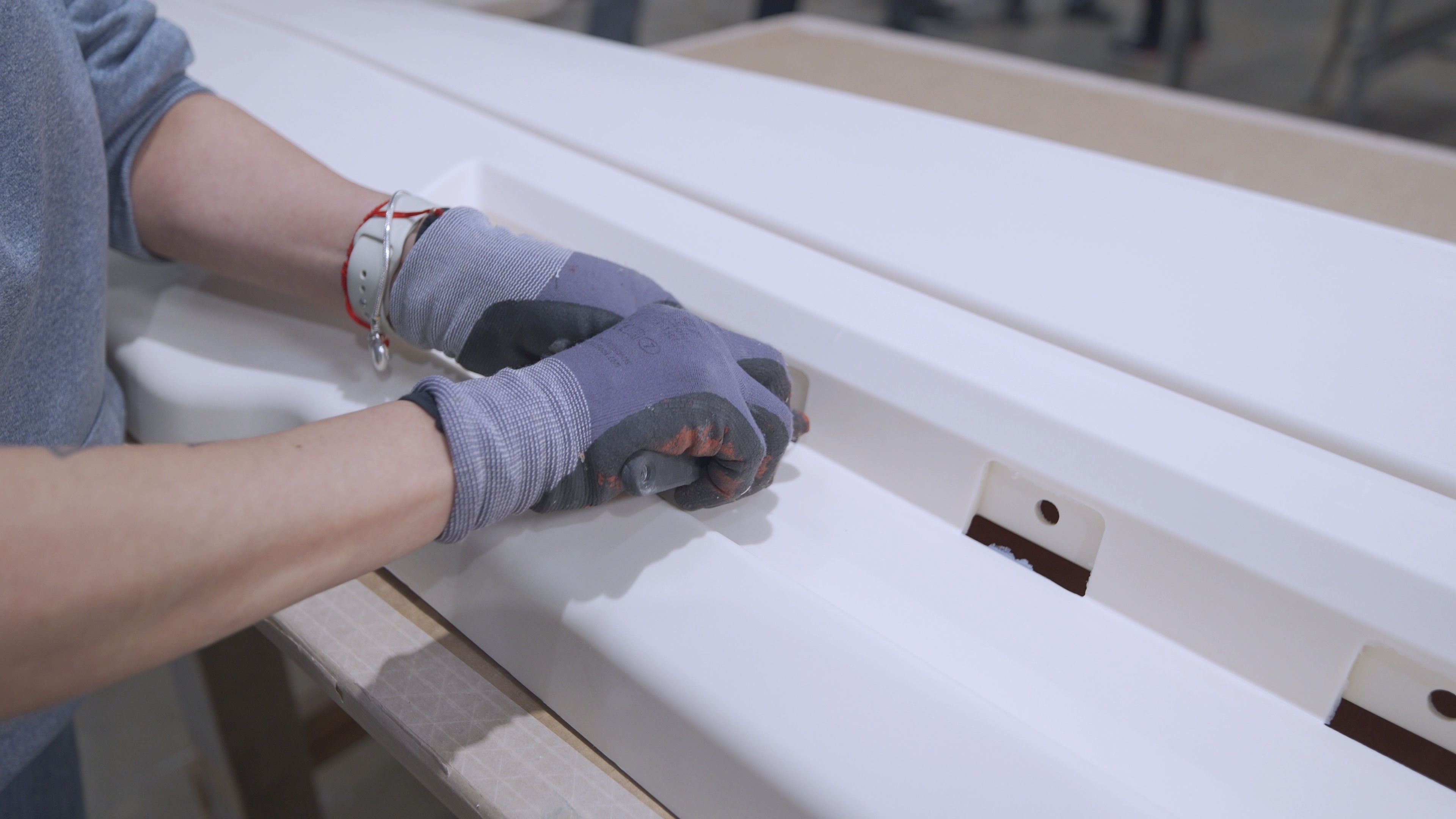 a worker removing flashing from a RIM molded part